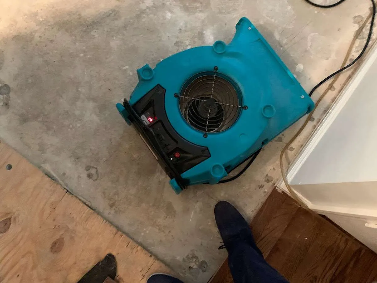 Air mover drying subfloor during Commercial Water Damage Restoration in Southeast Arcadia